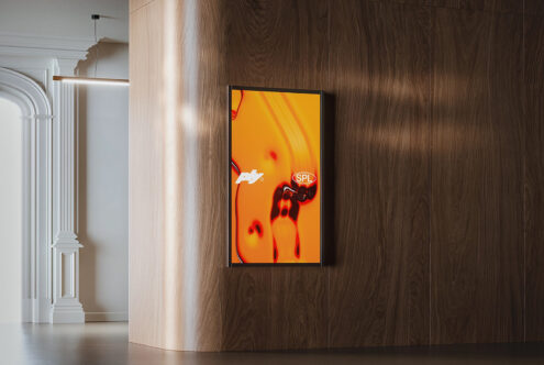 Portrait frame mockup with neon red bow graphic displayed on wooden interior wall