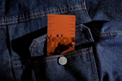 Orange clothing label mockup in denim jacket front pocket with button