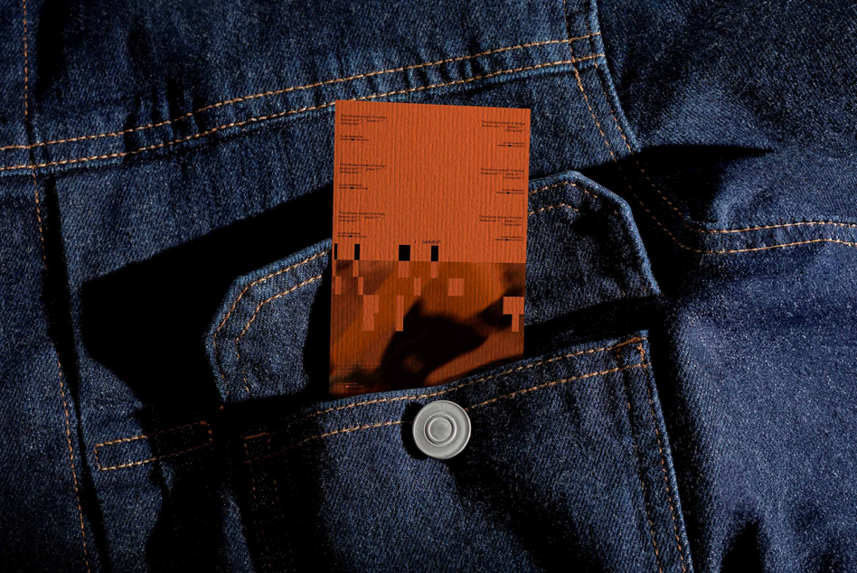 Orange clothing label mockup in denim jacket front pocket with button