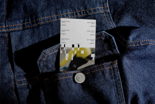 Clothing label mockup in denim jacket front pocket with metal button