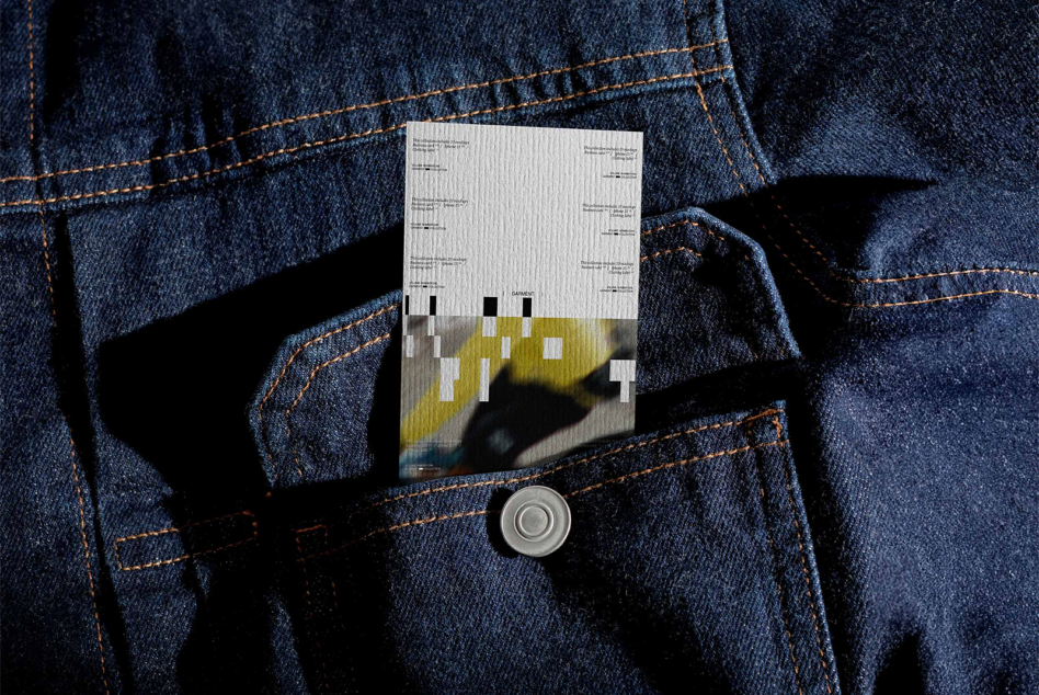 Clothing label mockup in denim jacket front pocket with metal button