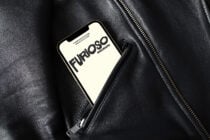 iPhone mockup on black leather jacket with cream screen display