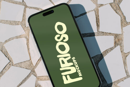iPhone with green screen showing Furioso Mockups text in cream color