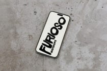 iPhone mockup on concrete surface displaying Furioso branding