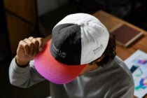Tri-color baseball cap with black white pink sections displaying Mockup Lab text