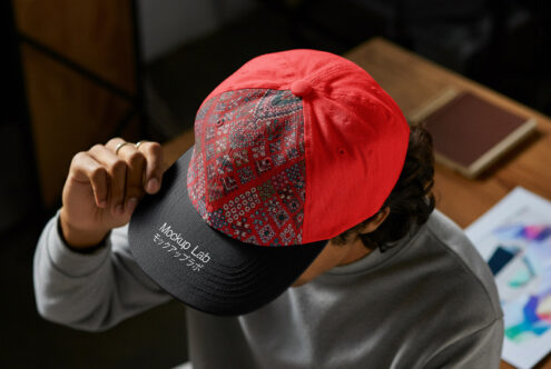 Red black baseball cap featuring textured pattern on front with Mockup Lab branding