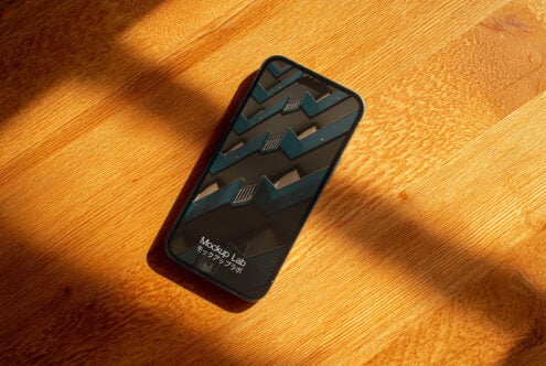 Dark phone screen showing geometric isometric 3D pattern design mockup