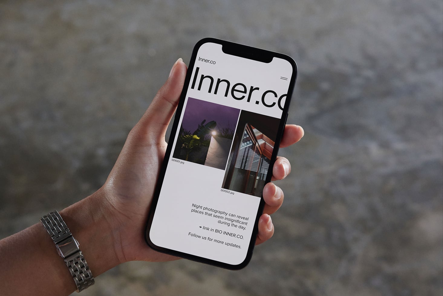 Inner.co light mode site on phone featuring night photography portfolio layout