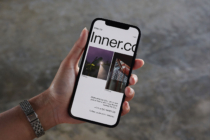 Inner.co light mode site on phone featuring night photography portfolio layout