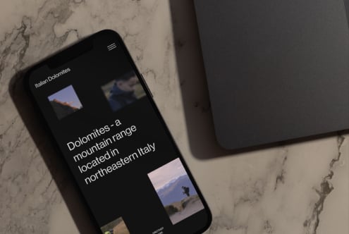 Italian Dolomites dark theme site on phone with scenic mountain photo gallery