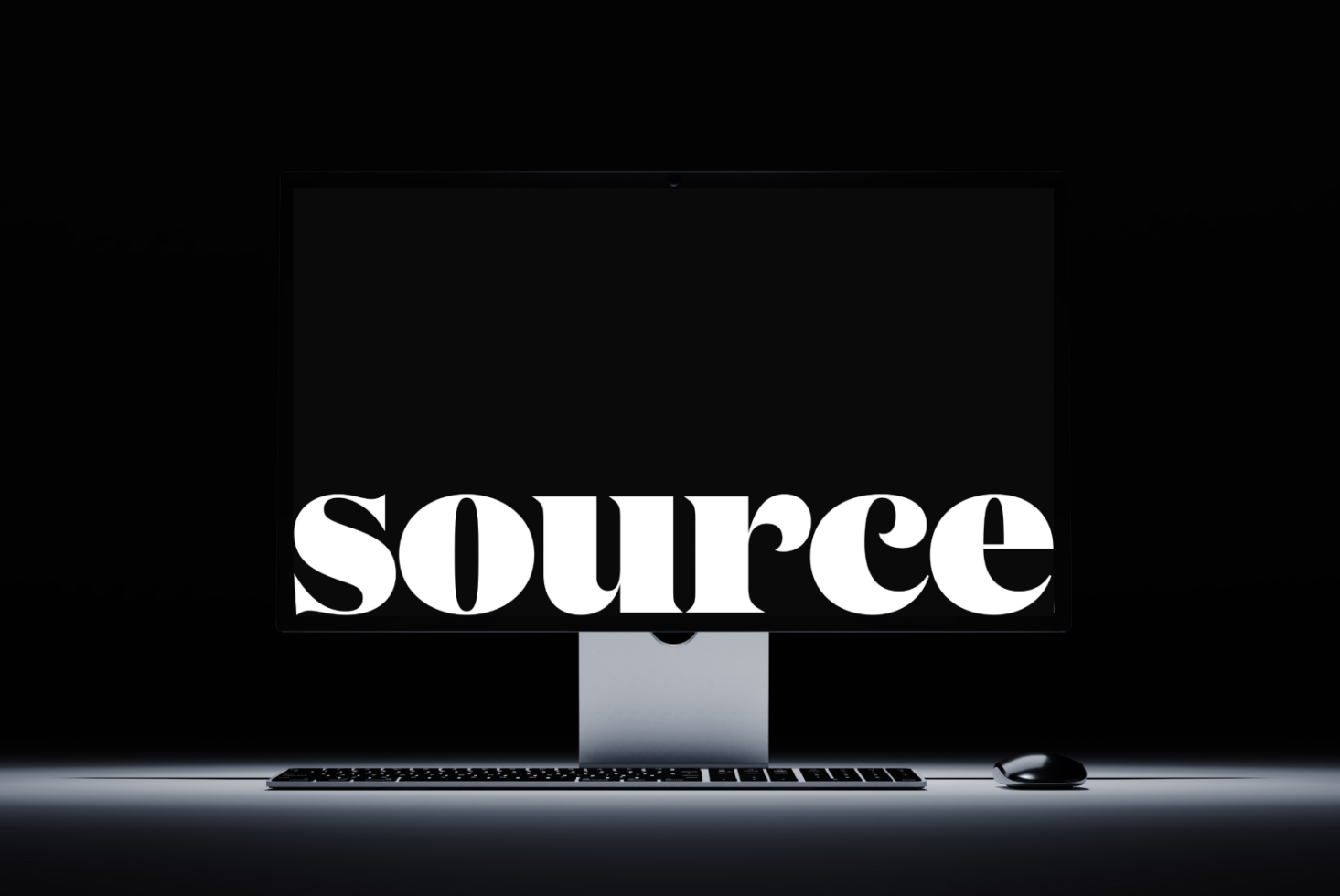Clean desktop setup with SOURCE text centered on monitor screen