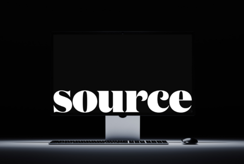 Clean desktop setup with SOURCE text centered on monitor screen