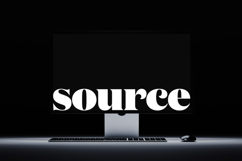 Clean desktop setup with SOURCE text centered on monitor screen