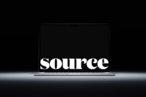 Large serif font spelling SOURCE glowing on dark laptop display