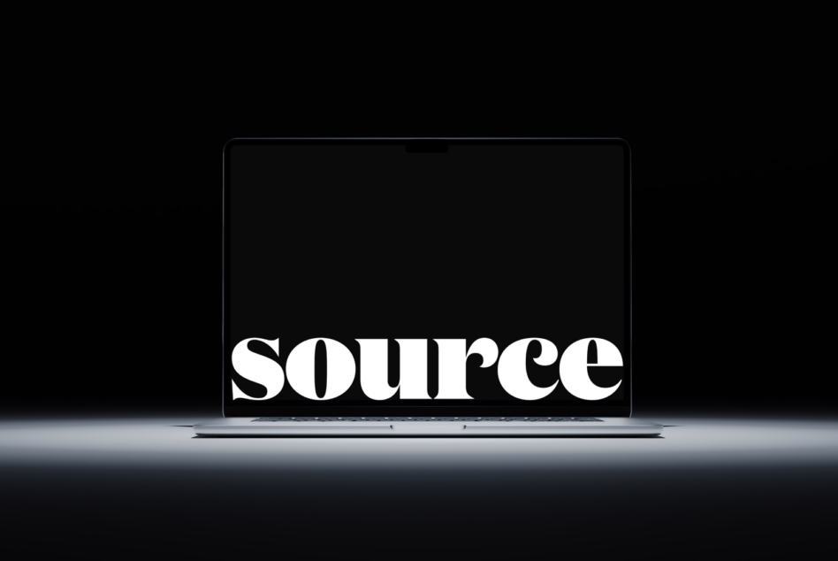 Large serif font spelling SOURCE glowing on dark laptop display