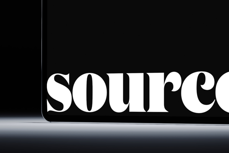 Tablet edge close-up showing 'source' text in white serif typeface
