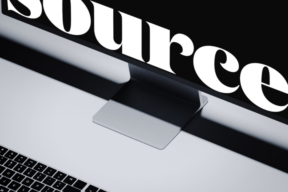 Oversized serif letterforms reading SURFACE angled across monitor setup