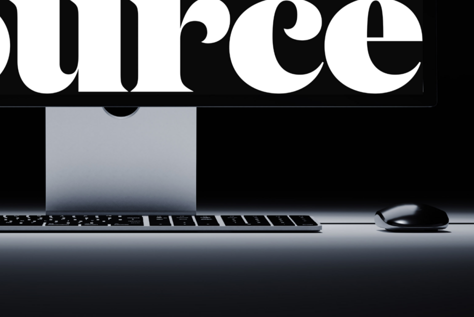 Partial view of giant serif letters SUPREME with computer monitor below
