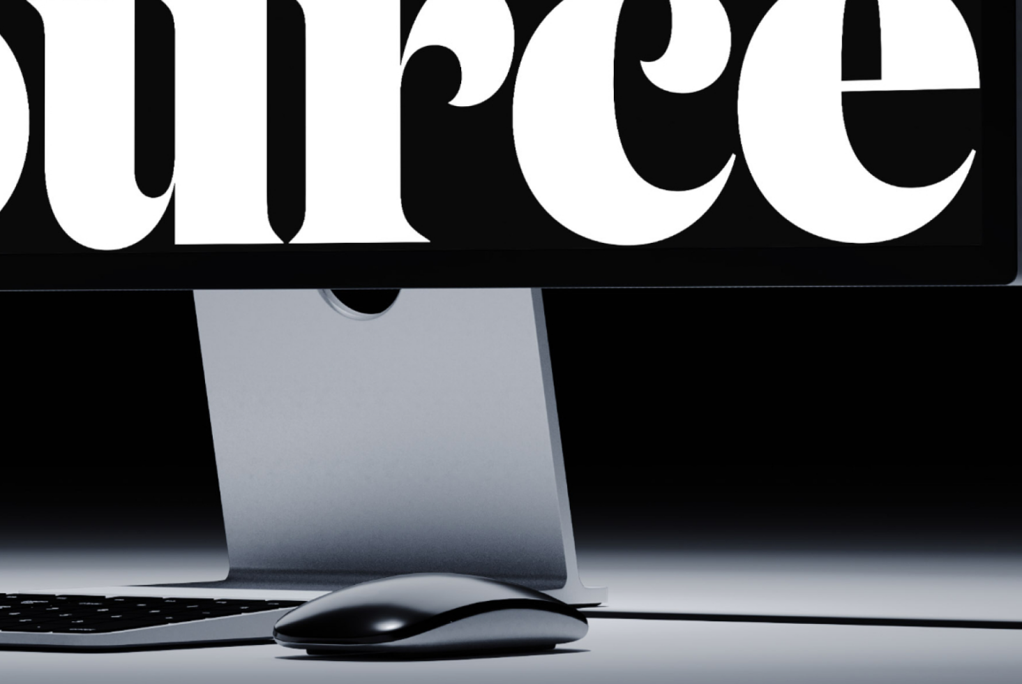 Oversized serif type SUPREME cropped with iMac computer underneath