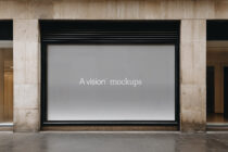 Wide storefront billboard with neutral gray screen showing A vision mockups text