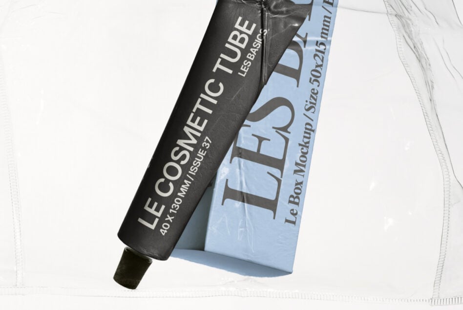 Black cosmetic tube with light blue box mockup tilted on white backdrop