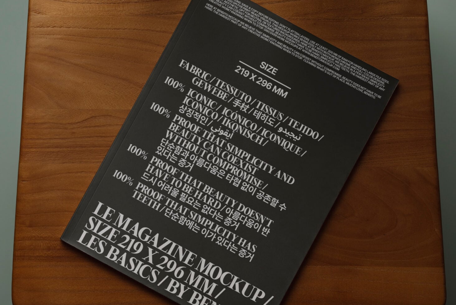 Black magazine mockup angled on wood table showing fabric content details