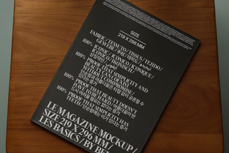 Black magazine mockup angled on wood table showing fabric content details