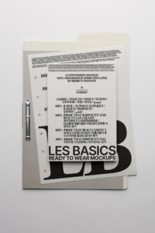 Cream folder with ring binding holding stationery mockup sheet showing Les Basics design
