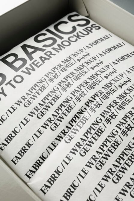 Open white box revealing blue paper mockup with bilingual typography mockup design