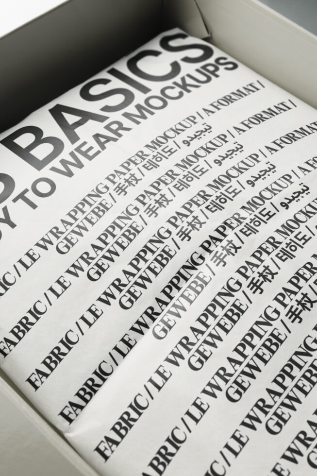 Open white box revealing blue paper mockup with bilingual typography mockup design