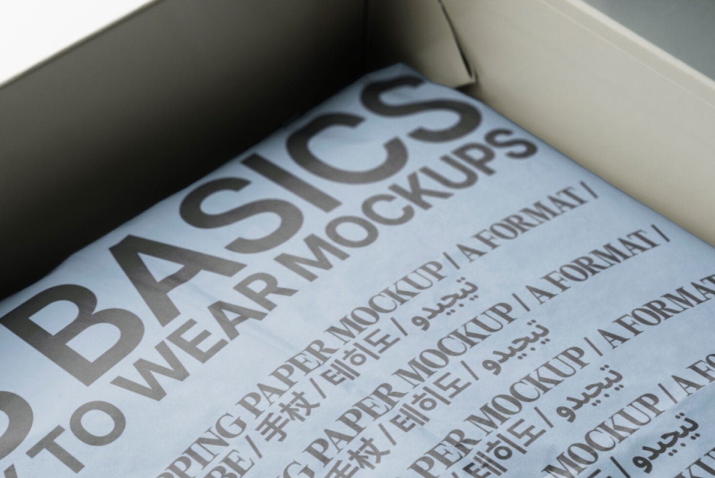 Inside open white box with blue paper mockup showing repeated text layout format