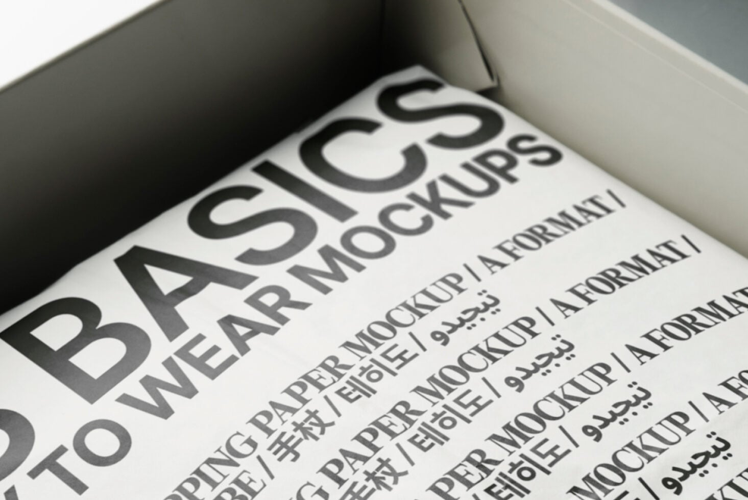 White box interior displaying cream paper mockup with bold black headline typography