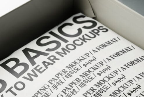 White box interior displaying cream paper mockup with bold black headline typography
