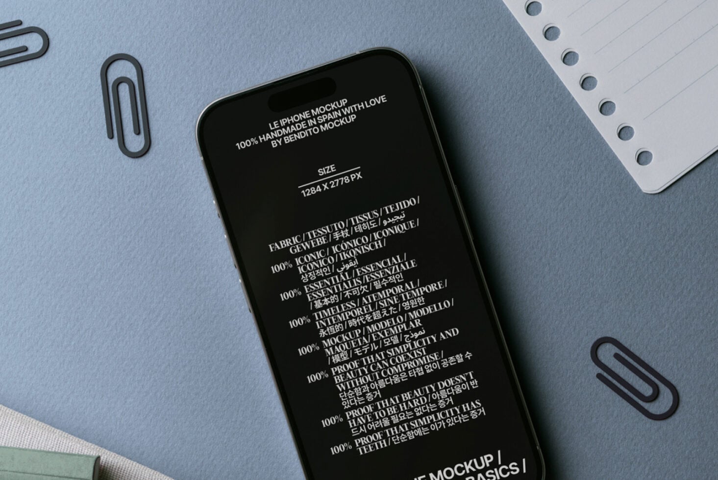 iPhone mockup with black screen displaying multilingual text, charged with white cable against desk setup