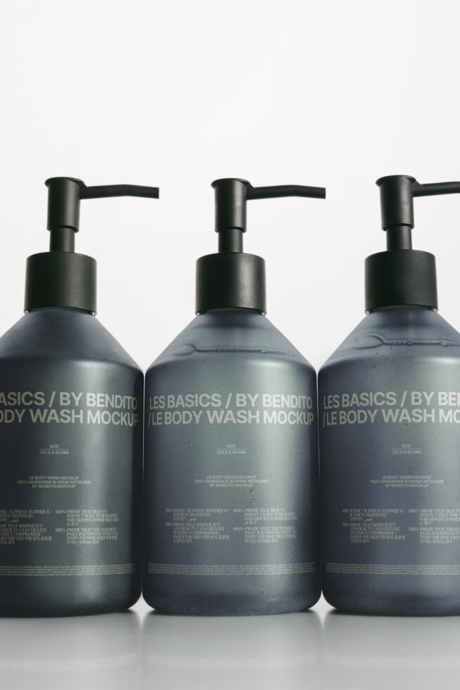 Three dark pump bottle mockups filled with gray liquid on white background