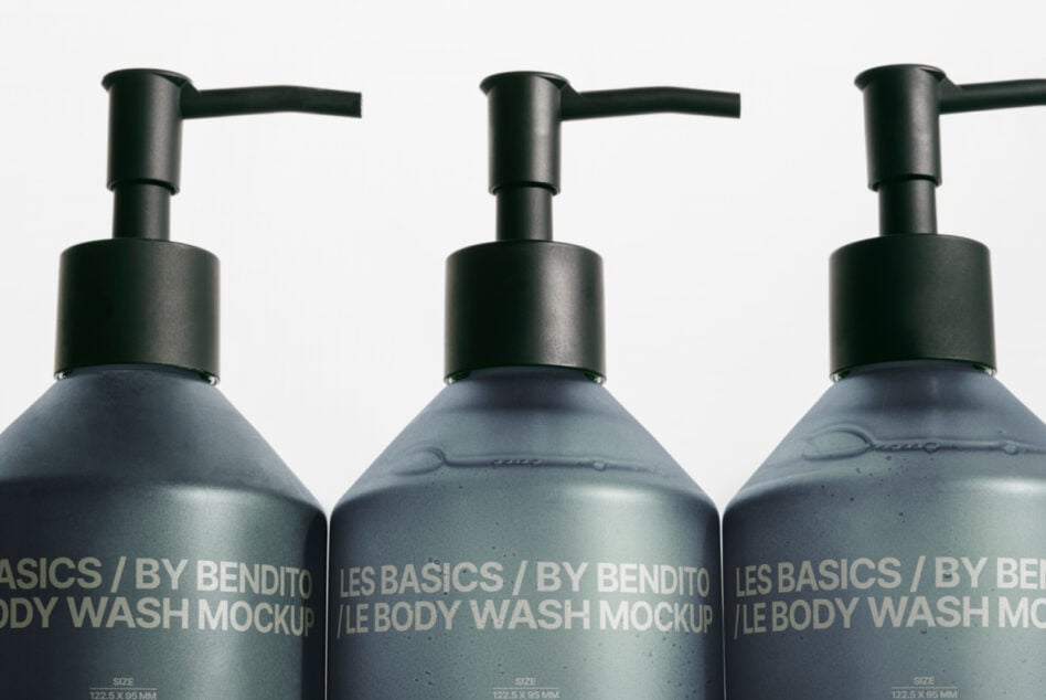 Close up of three dark pump bottles with gray liquid, black pump tops visible