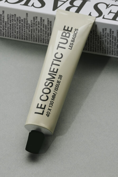Cream cosmetic tube mockup showing LE COSMETIC TUBE branding on neutral background