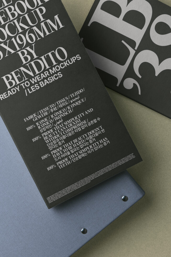Dark hardcover book mockup next to geometric patterned fabric sample overhead view