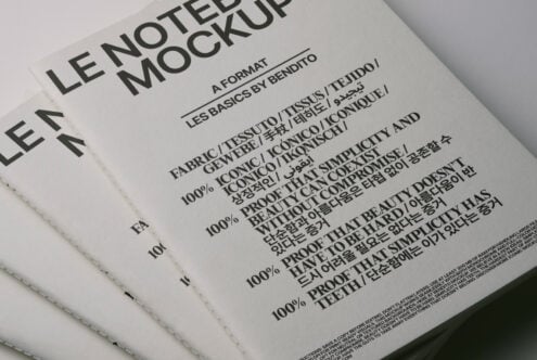 Offset white notebook stack with stitched binding displaying typography mockup