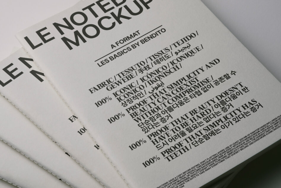 Offset white notebook stack with stitched binding displaying typography mockup