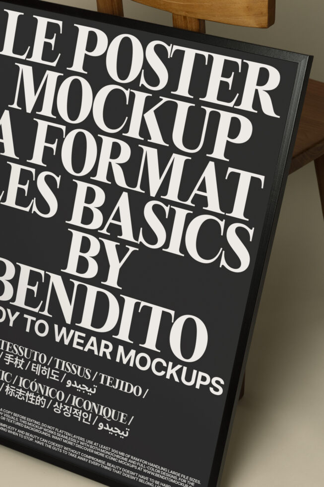 Black poster mockup in frame showing large serif type on wooden background