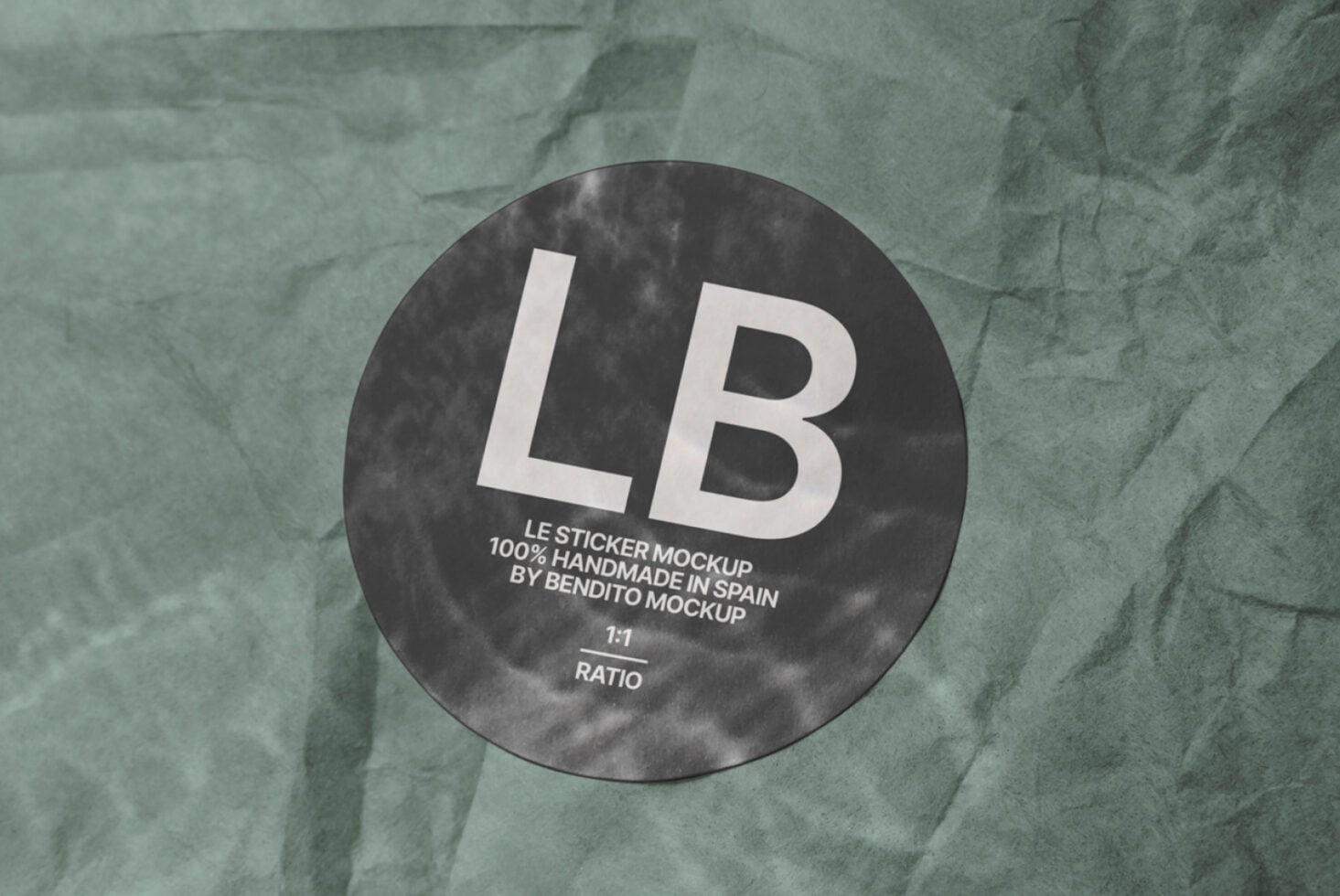 Dark circular sticker mockup with white LB text on textured green paper