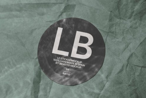 Dark circular sticker mockup with white LB text on textured green paper