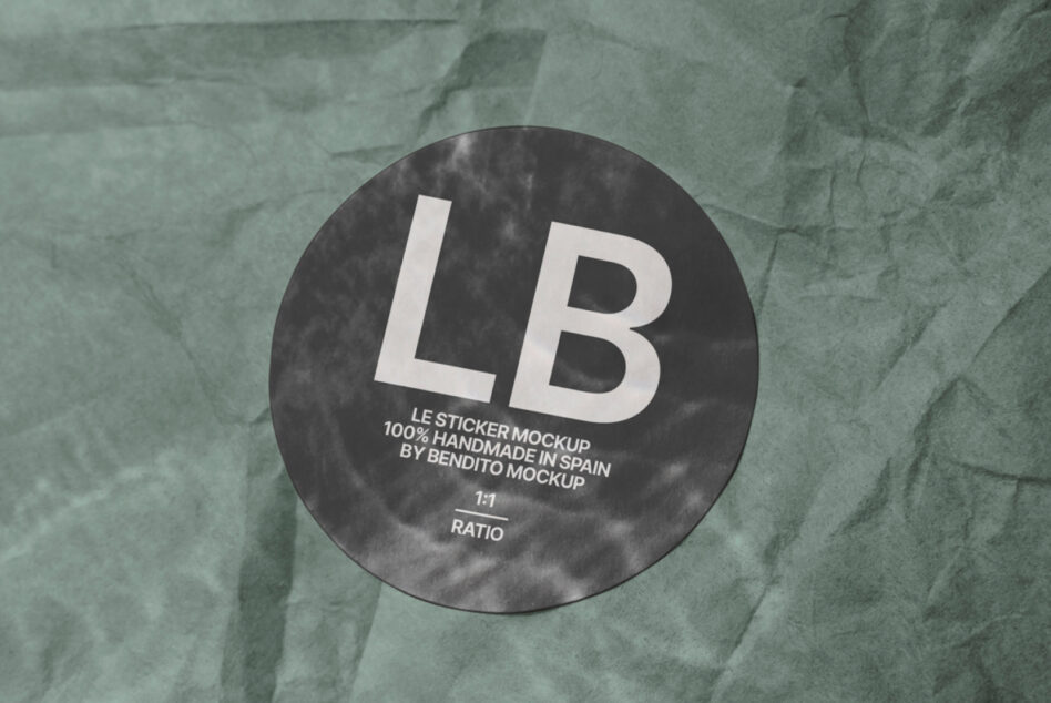 Dark circular sticker mockup with white LB text on textured green paper