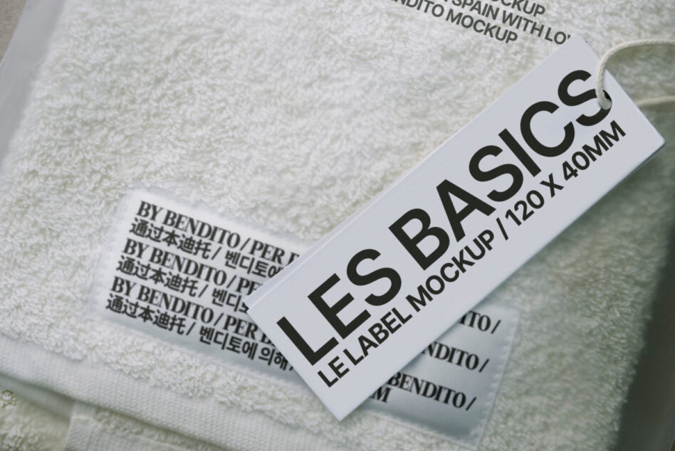 White fabric label mockup angled on cream textile background