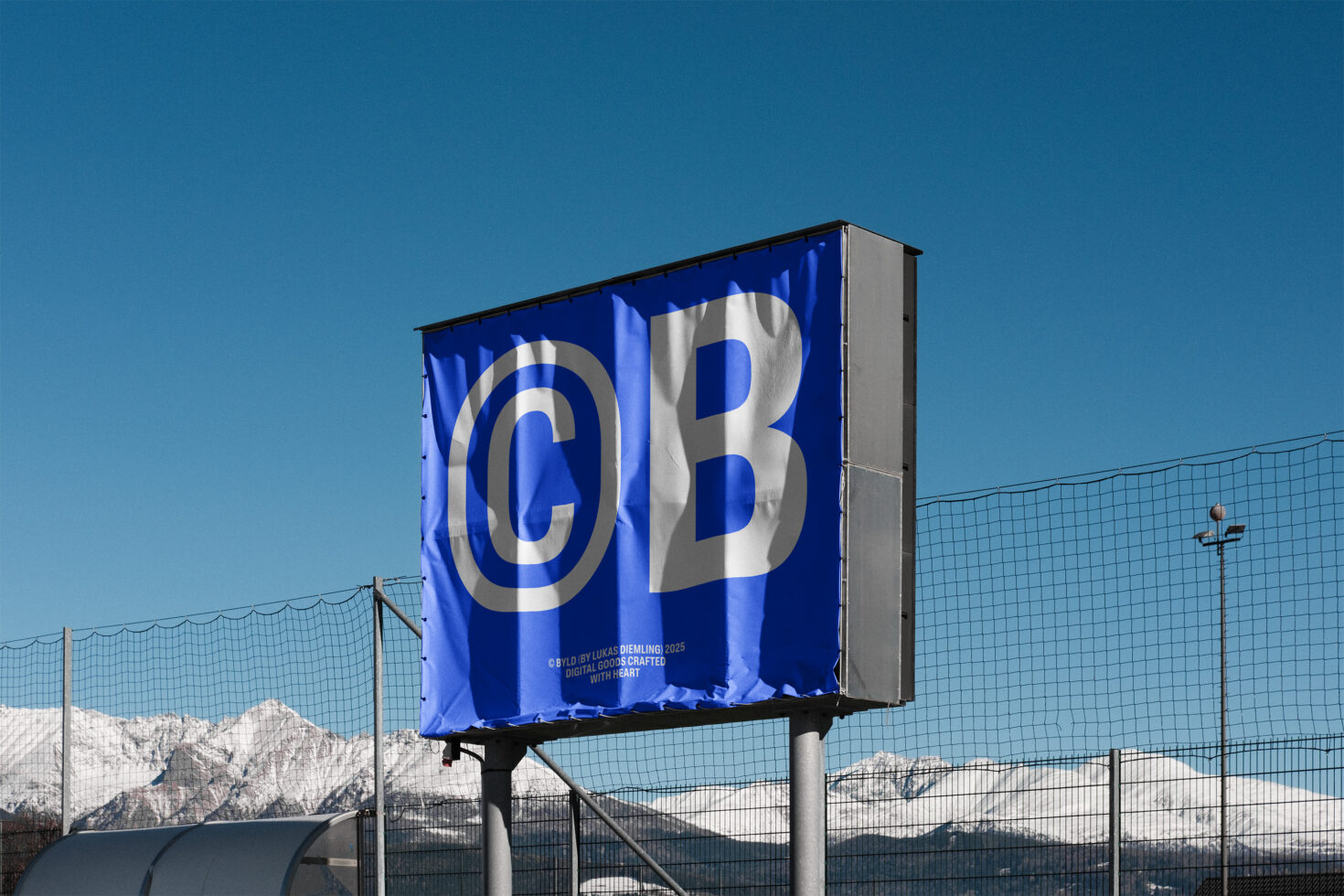 Blue billboard mockup with large white letters against snowy mountains backdrop