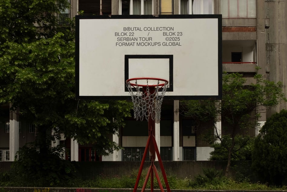 White basketball backboard with red rim, chain net visible against light background signage