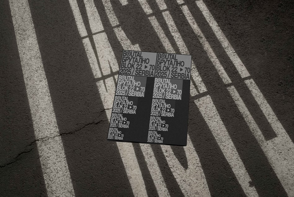 Black poster mockup photographed on ground with building shadow patterns