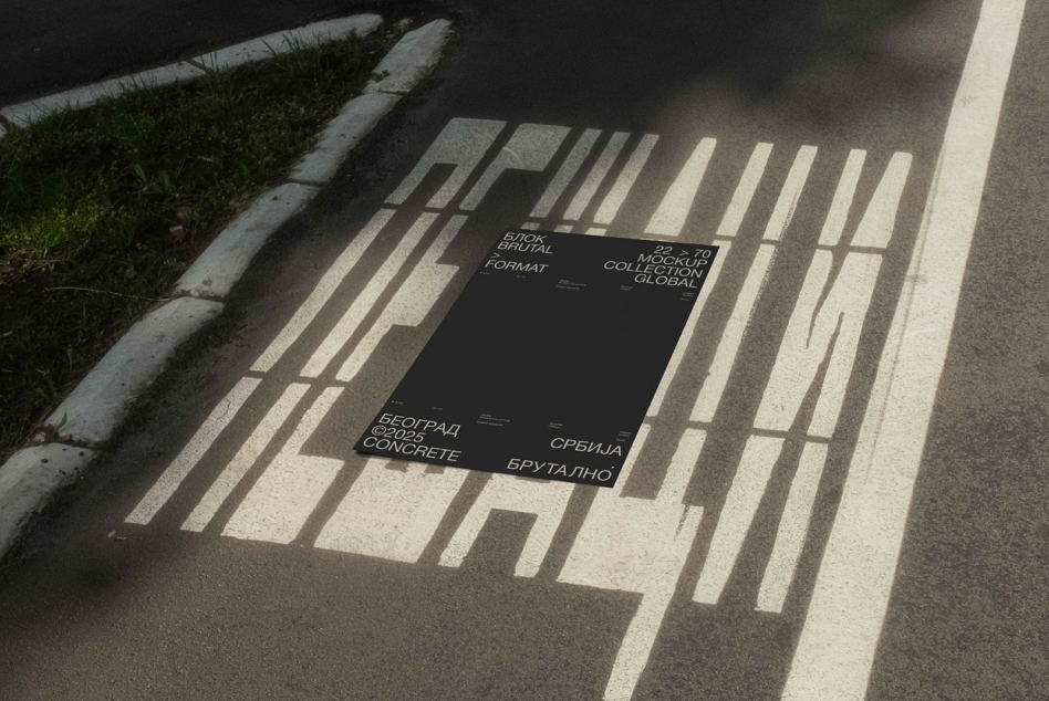 Black poster mockup on sunlit concrete with bold sans serif typography
