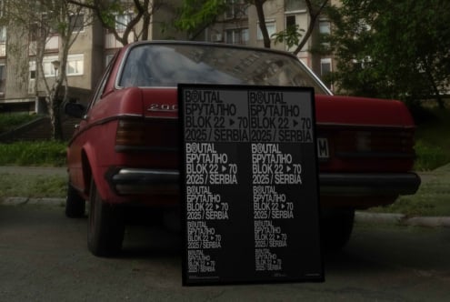 Red vintage car holding up large poster mockup with bold typography layout